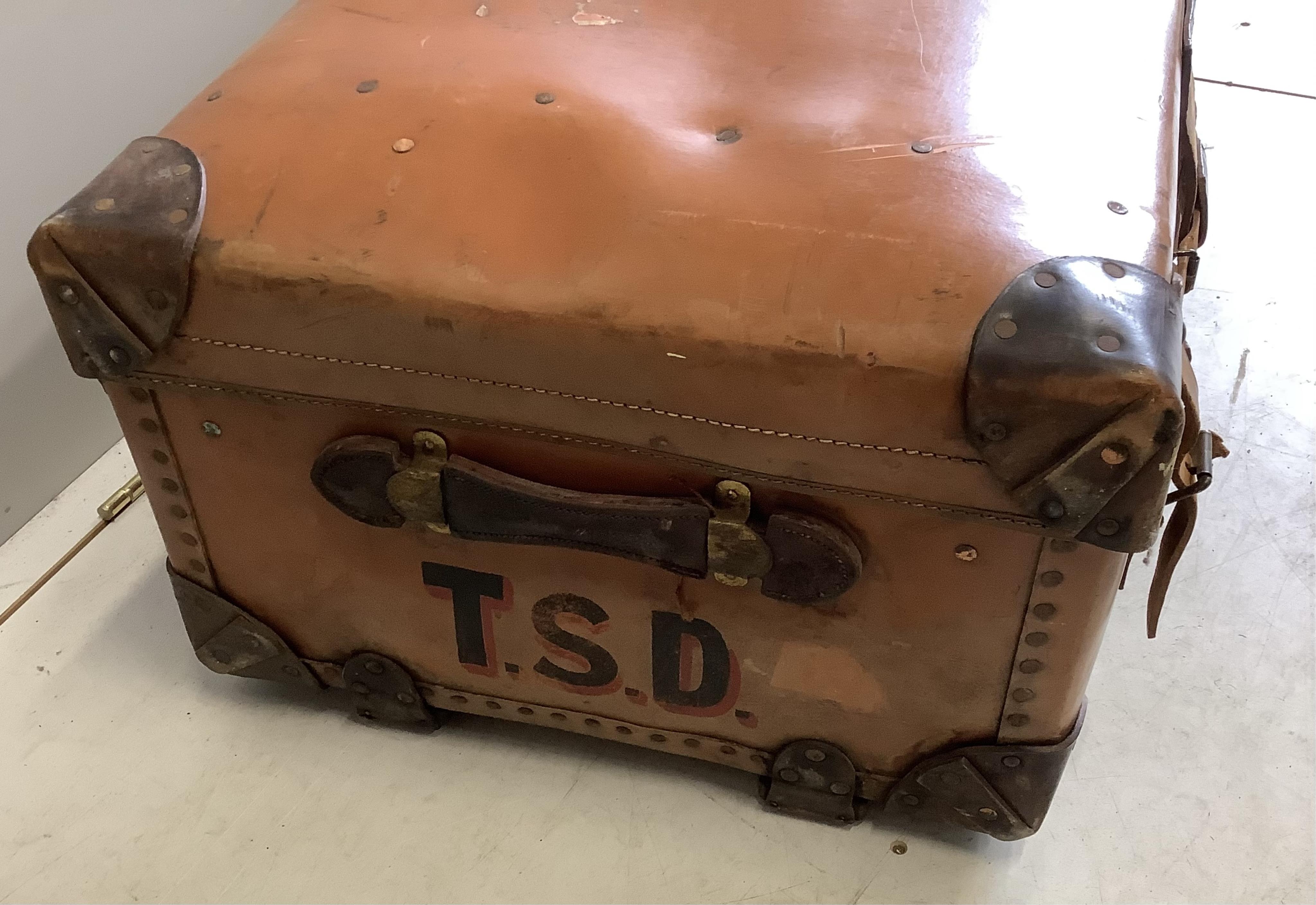 An early 20th century leather mounted travelling trunk, width 76cm, depth 52cm, height 32cm